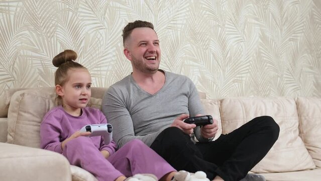 Family time at home father with daughter. Weekend activities, free time, home entertainment and video games concept.