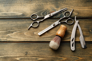 Set of professional barber tools on wooden table