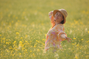 young woman in a field with rapeseed