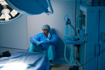 Tired exhausted exhausted surgeon after long surgery doctor in operating room