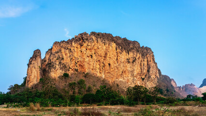 Beautiful view landscape of rock mountains cut by drilling and bomb blasting. Mountains was bombed to get stones for construction. Traces of the mountain was bombed because the stone industry.