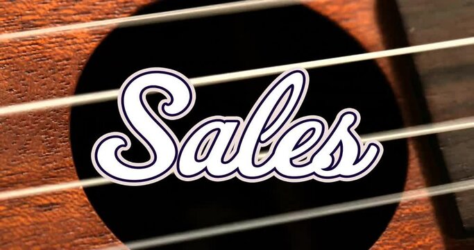 Animation of sales text over hand playing guitar