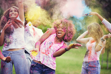 Friends, happiness and powder paint at color festival in park, fun with celebration or party outdoor. Freedom, bonding and colorful mess in nature, joy and culture with people at summer event - obrazy, fototapety, plakaty
