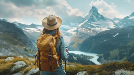 Fototapeta na wymiar Wanderlust adventure: woman with backpack gazing at majestic mountains and forests - travel concept image with copy space