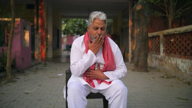 Grey-haired Indian man coughing badly - lungs infection  weak lungs  asthma  flu infection  seasonal infection . Sick asian grandfather suffering from throat pain and dry cough - village lifestyle ...