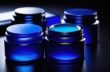 blue jars  without inscriptions for skin care on a dark background in backlight with space for text