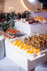 Serving the festive table at a wedding event. Decorating the wedding table with bouquets of flowers. Cutlery at a party