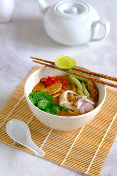 laksa ikan, asam laksa, rice noodle,vegetables, filet fish with sour soup, popular in penang, malaysia