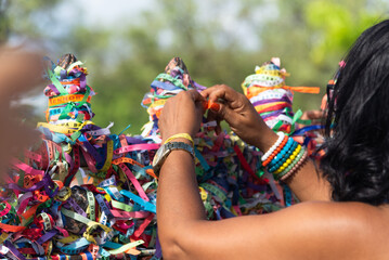 A Catholic faithful is seen tying a souvenir ribbon on the railing of the Senhor do Bonfim church in the city of Salvador, Bahia.