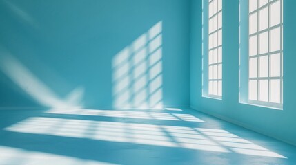 Minimalist abstract light blue background for product presentation with light and shadow from windows on wall.