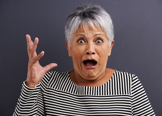 Shock, portrait and senior woman in studio with fear, scared and terror facial expression....