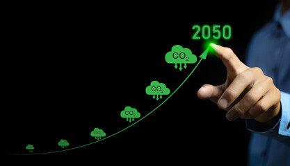 Net zero emissions by 2050. Businessman touching climate growth arrow to change climate and net...