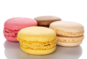 Four sweet macarons, macro, isolated on white background.