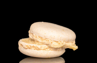 One sweet macaron, macro, isolated on black background.