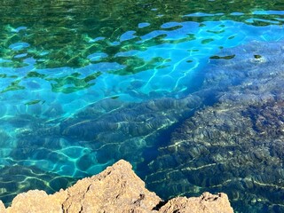 Sea turquoise blue clear water with algae of Mediterranean coast.