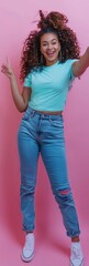 Fototapeta premium Full body photo of an excited woman wearing jeans and mint shirt, standing in front on pink background pointing to the side with her finger. She is looking at something she would like very much, laugh