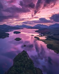 Aerial shot of Loch Alsh, Scotland at dusk, with purple clouds and pink water reflections amidst islands and mountains, evoking beauty, relaxation, and romance.