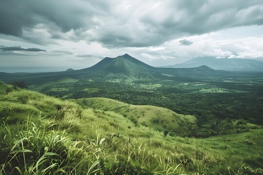 Captivating film photograph showcasing lush green hills with a majestic volcano looming under a cloudy sky, viewed from an elevated perspective.
