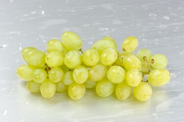 Bunch of White Grapes on Brushed Aluminum Background