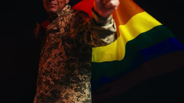 A close-up of a soldier proudly holding rainbow flag, lgbt people in the army