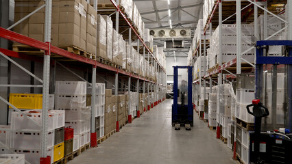 Industrial food warehouse with boxes. Large warehouse with boxes of meat, production of meat products.