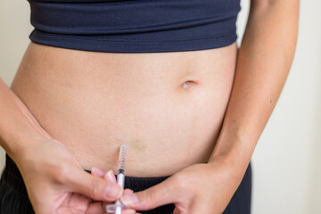 IVF and infertility treatment concept, woman have injection on her belly - 758123846