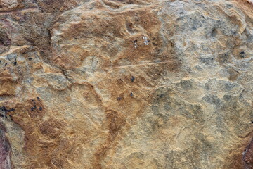 Texture of a quarry stone in browns, rust and streaks
