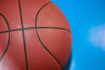 Basketball ball on a blue background close-up, sports background