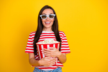Photo of pretty astonished girl hold big popcorn bucket watch movie 3d glasses empty space isolated...