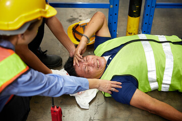 senior worker fell over and his head is bleeding on the floor in the factory