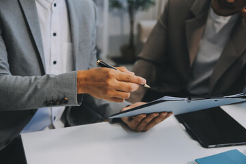 Young stressed Asian businessman working in the office. Businessman thinking too much work concept in the office.