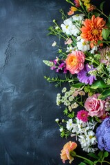 Beautiful bouquet of spring flowers on a blackboard background, top view. Greeting card with space for text.
