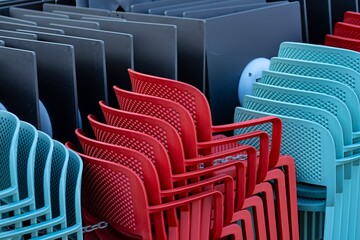 Stacks of plastic chairs and tables.