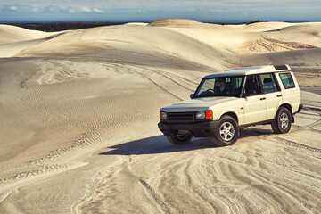 Car, desert and driving with travel and transportation outdoor, off road vehicle for sand dunes and...