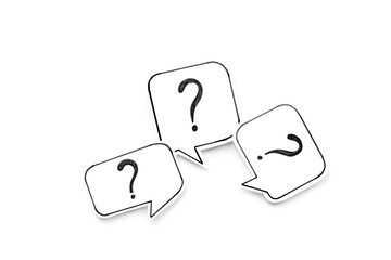 FAQ concept - paper speech bubbles with question mark, top view