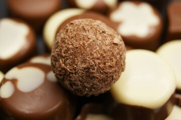 Chocolate ball on a background of chocolate candies. High quality photo