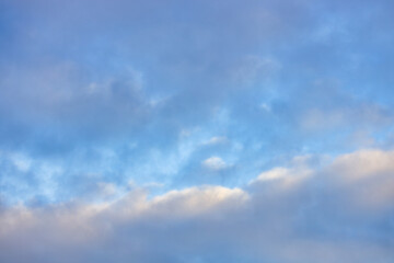 A beautiful sky tinted by the sun leaving vibrant shades of gold, pink, blue and multicolored. Clouds in the twilight evening and morning sky. Cloudy sky background in the evening and during the day.