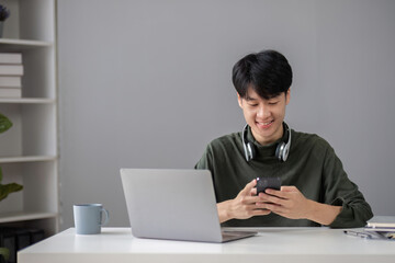 Portrait of a handsome young office worker intently studying how to do a presentation project on a laptop in his office.