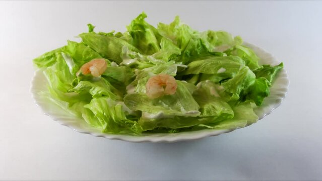 Preparation of Caesar salad with shrimp. Stop motion.