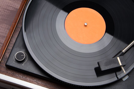on a vinyl record player, playing music from old speakers