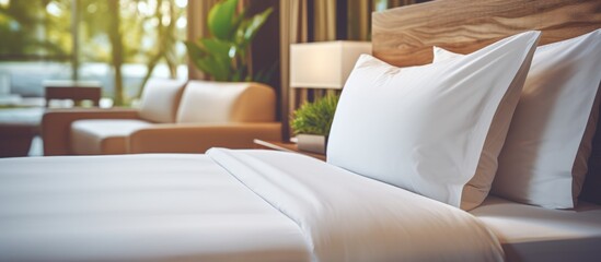 Hotel bedroom with white pillow and wooden bed close-up.