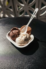 A Bowl of Flavored Ice Cream on a Black Surface