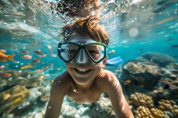  A young boy with a snorkel mask and fins, peering beneath the surface of the water to marvel at the vibrant marine life of a bustling coral reef, his face alive with wonder and awe © Maelgoa