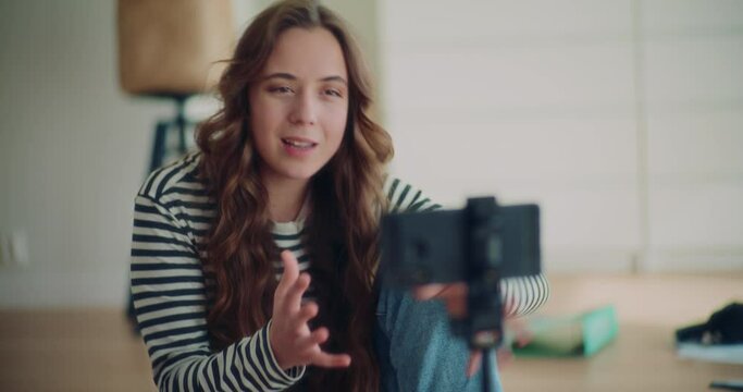 Attractive female brunette influencer doing live broadcasting