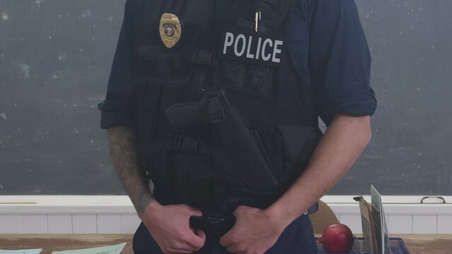 Police officer close up at head of school classroom