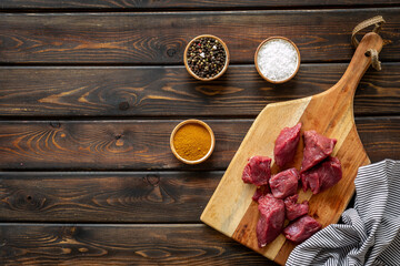 Beef meat on wooden board ready for cooking. Food background