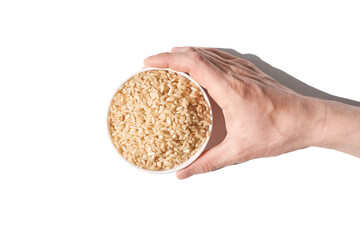 A bowl of uncooked brown rice, isolated against a white background. Healthy, savory dish includes whole grains like jasmine and basmati, showcasing a dieting Asian cuisine.