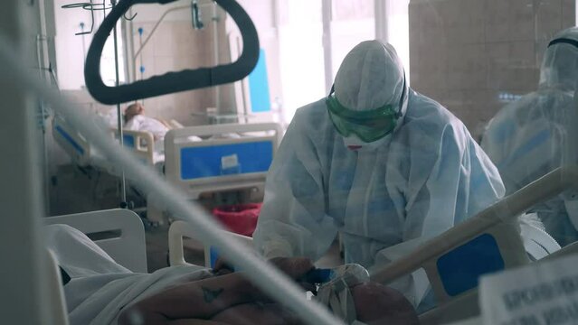 Doctor in the red zone of coronavirus clinic is working with a patient