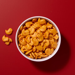 Cheese crackers in a bowl on a red background