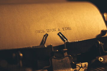 ONCE UPON A TIME typed words on a vintage typewriter. Close up. Antique Typewriter.